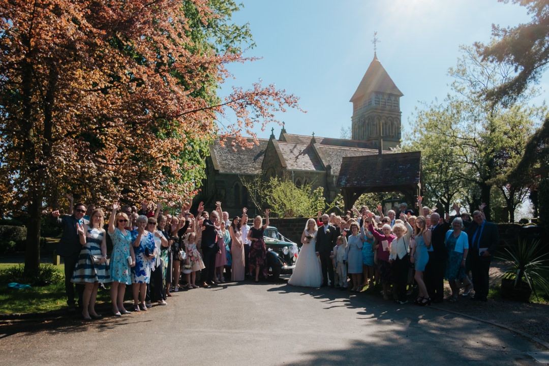 Group photograph outside Old Milverton Church on Alex & Dan's wedding day