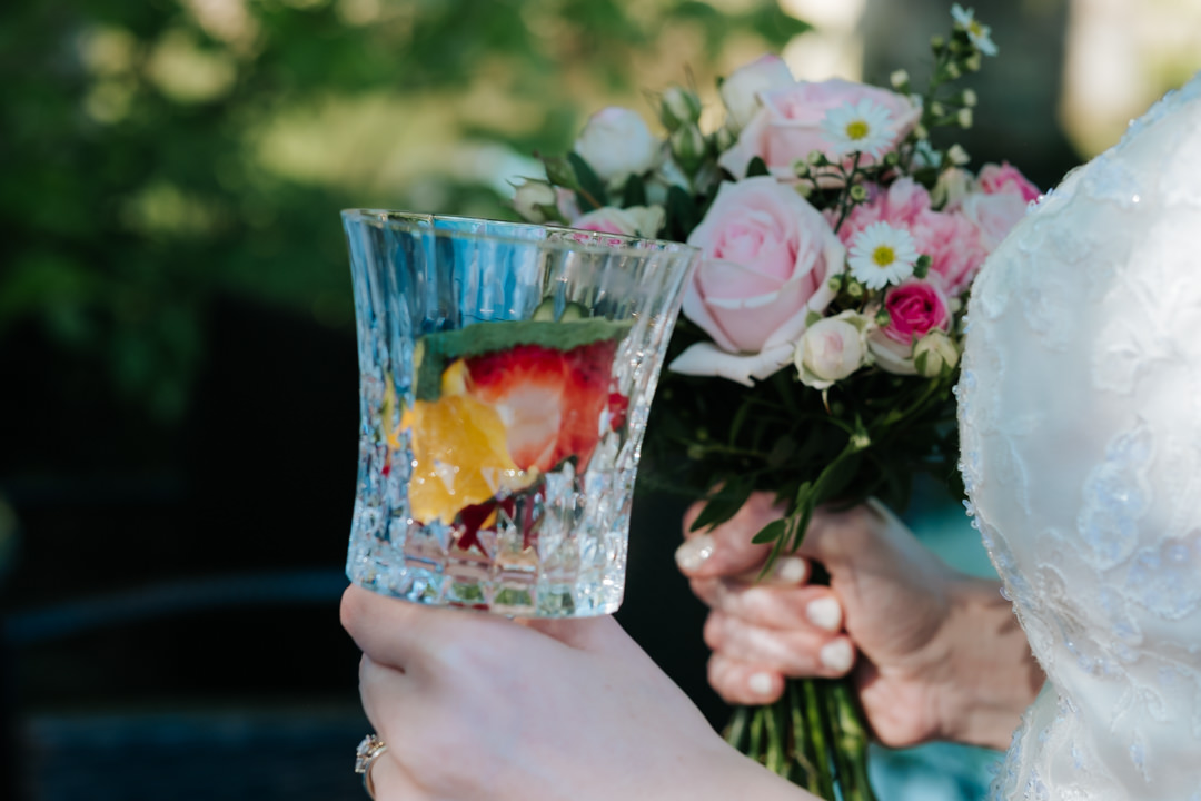 Saxon Mill wedding. bride holding pimms and pink and white bridal flowers