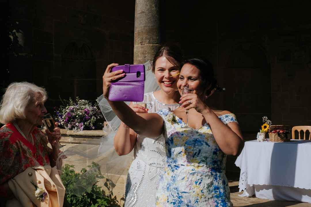 Bride and friend take a selfie at t Nymans Garden Wedding