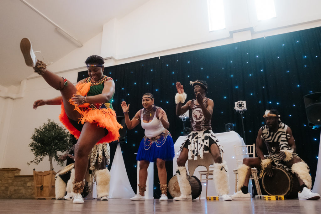 female African dancer performs at Worton Hall as part of a fusion english and african wedding party