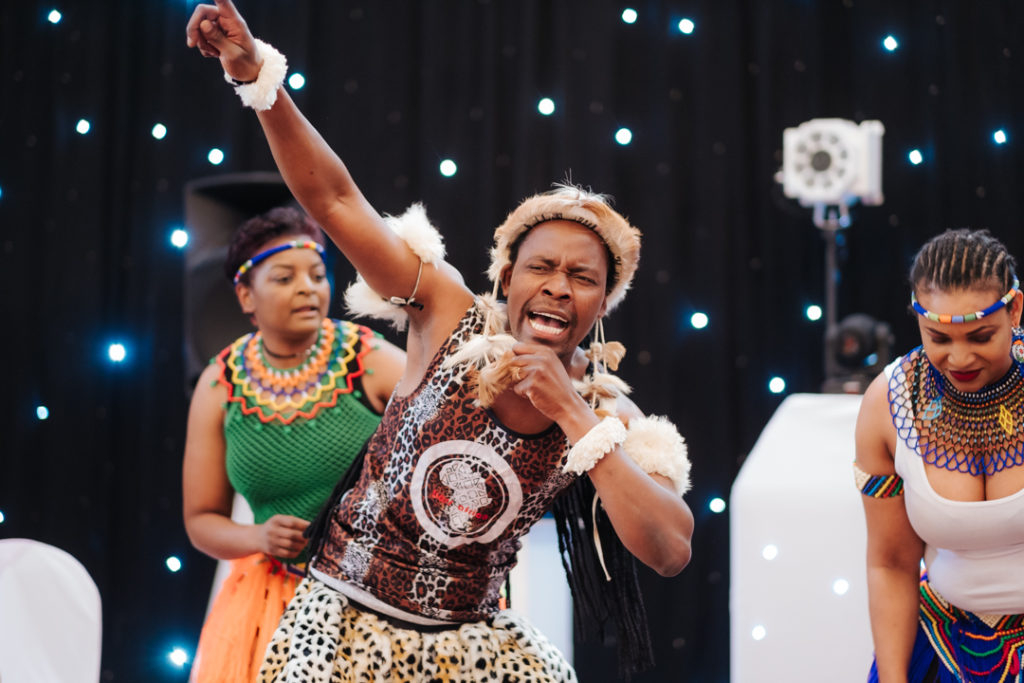 African dancer performs at Worton Hall as part of a fusion english and african wedding party