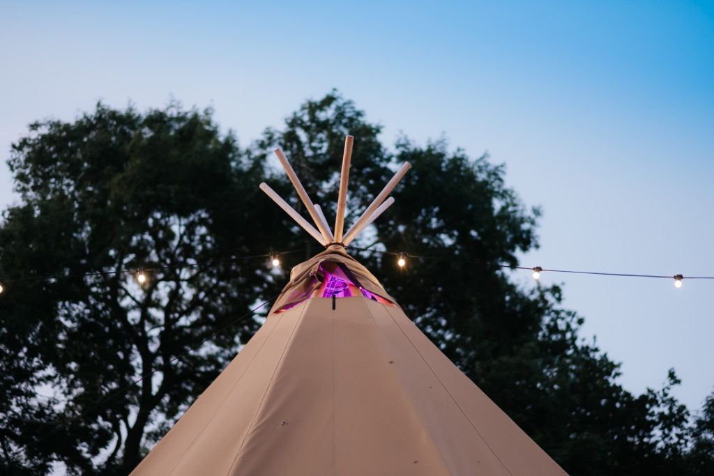 The top of the tipi photographed at dusk to show the beautiful purple sky at Hadsham Farm Wedding venue