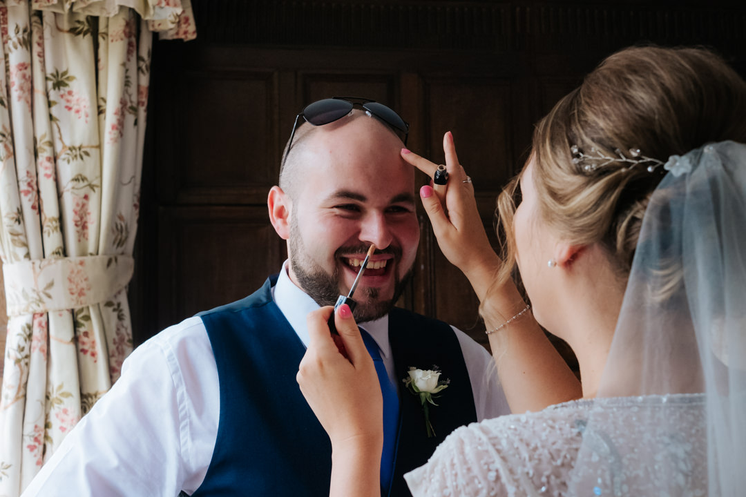Bride applied concealer to her brother's head whilst getting ready for her wedding at Gravetye Manor