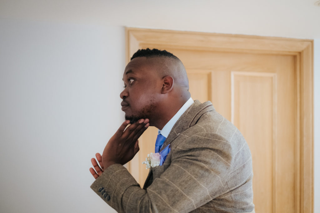 African Groom getting ready for his outdoor wedding ceremony at Worton hall Oxfordshire