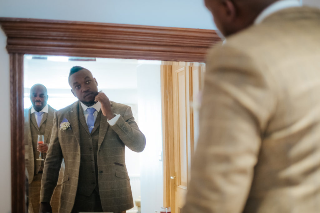 African Groom getting ready for his outdoor wedding ceremony at Worton hall Oxfordshire